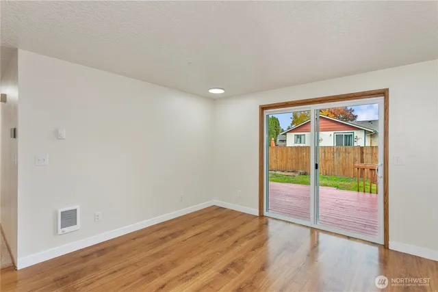 a view of an empty room with wooden floor
