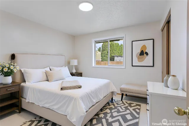 a bedroom with a bed and a desk