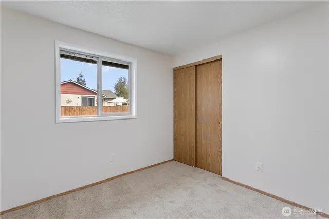 a bedroom with a bed and a potted plant