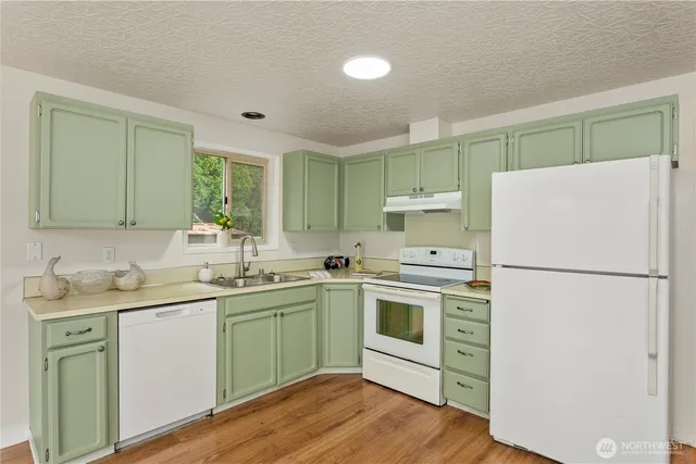 a kitchen with a white cabinets and white appliances