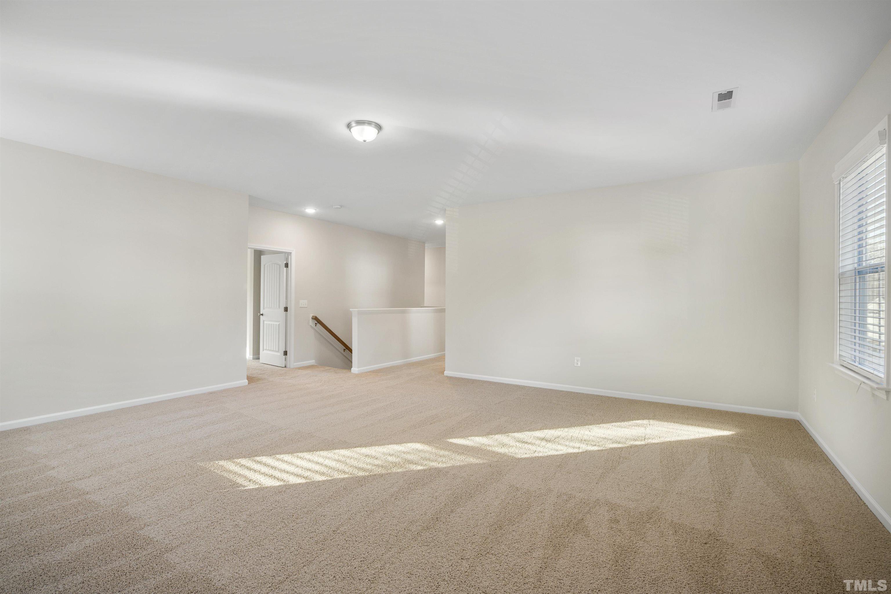 516 Gianna Drive, Unit 449 Clayton, NC 27527 - Photo 6 of 21 a view of an empty room with a window