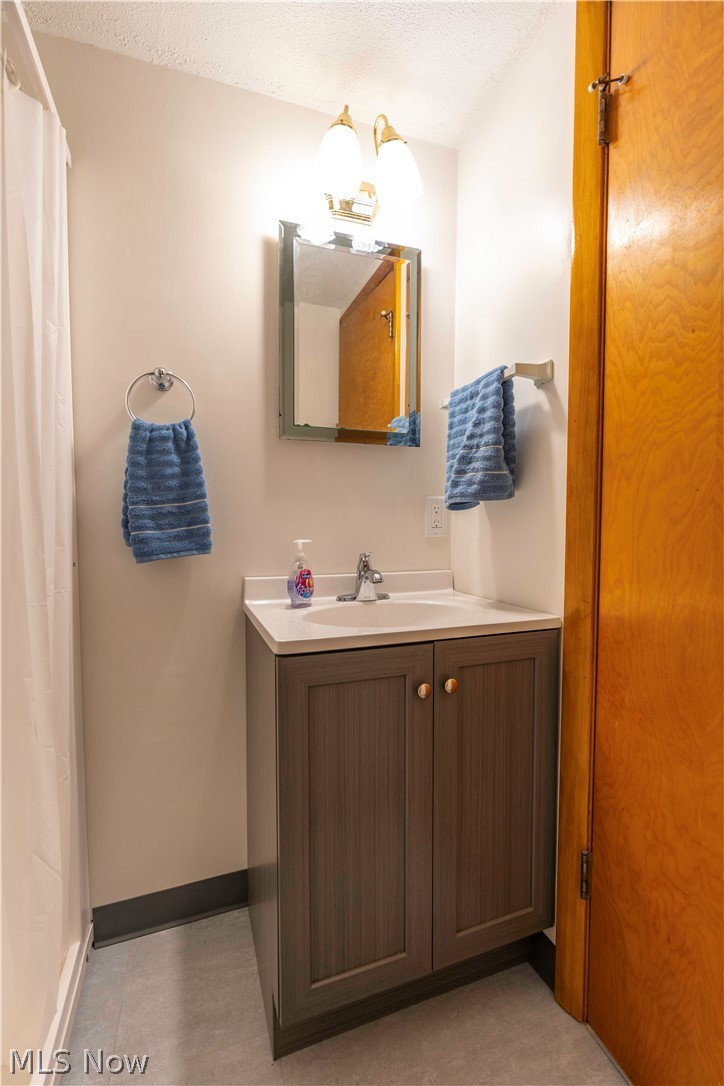 2159 Portage Line Road Mogadore, OH 44260 - Photo 25 of 35 Bathroom featuring vanity and a textured ceiling