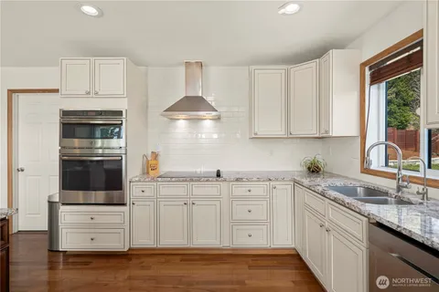 a kitchen with stainless steel appliances a sink stove and cabinets