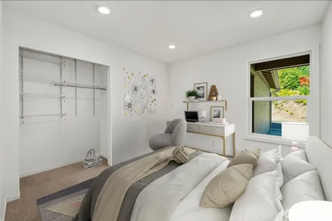 a bedroom with a bed and a window