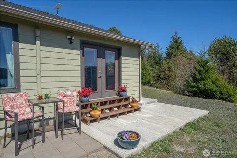 a backyard of a house with table and chairs