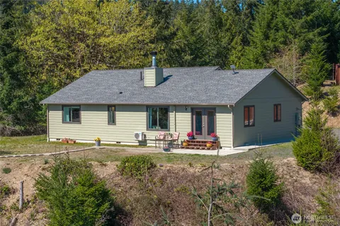 a front view of house with yard outdoor seating and green space