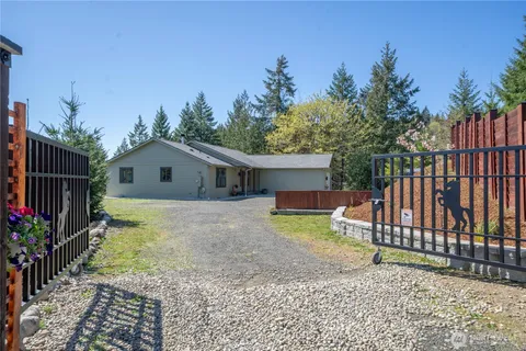 a view of a yard with wooden fence