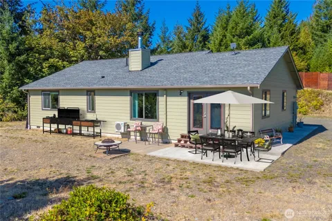 a view of house with patio and outdoor seating