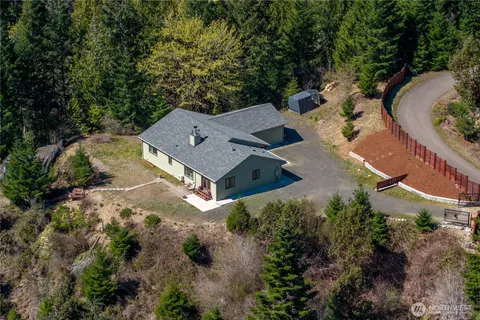 an aerial view of a house with outdoor space and street view