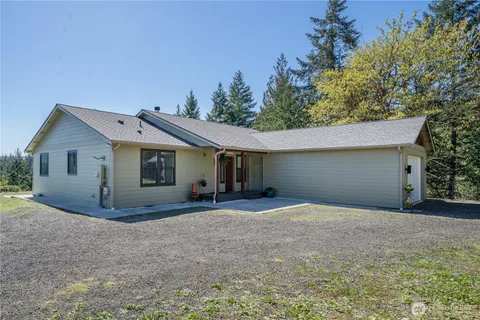 a view of a house with a yard and garage