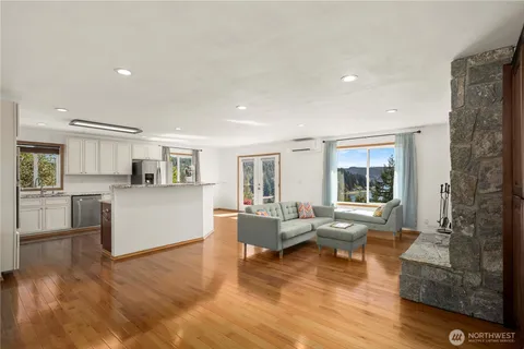 a living room with furniture and large windows