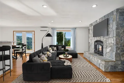 a living room with furniture a fireplace and a flat screen tv