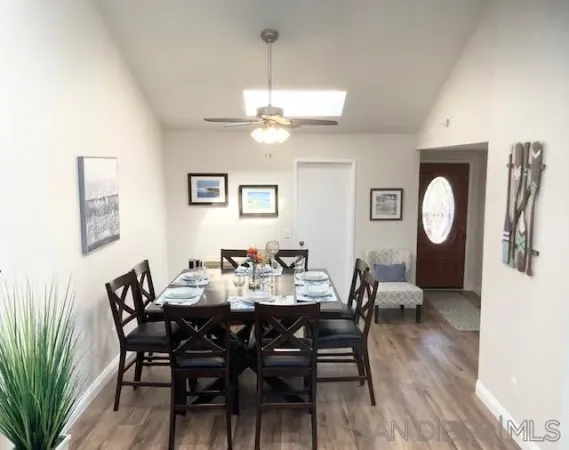 a view of a dining room with furniture and a chandelier