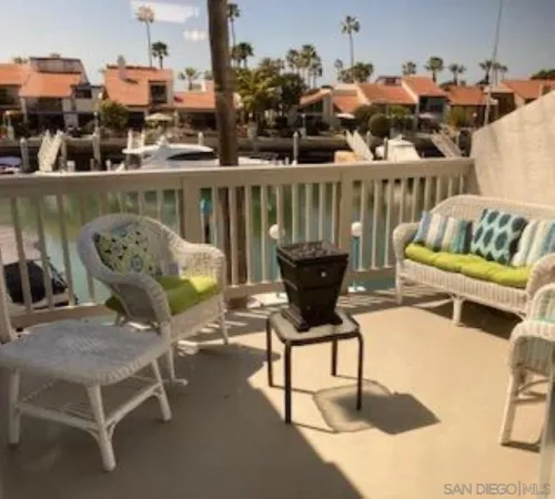 a roof deck with table and chairs