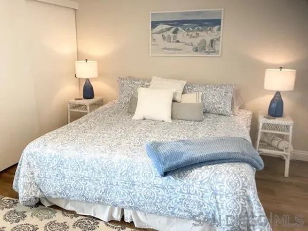 a bedroom with a bed and a lamp on table