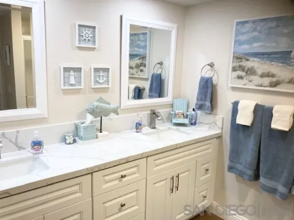 a bathroom with a double vanity sink and a mirror