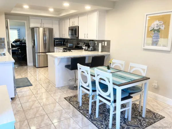 a kitchen with stainless steel appliances a stove a sink a microwave a refrigerator and cabinets