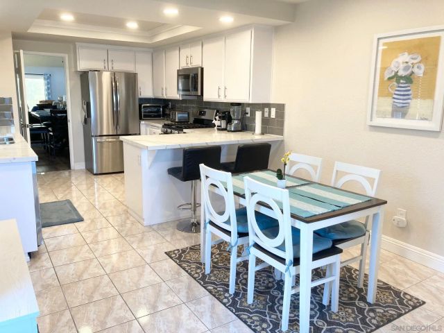 a kitchen with stainless steel appliances a stove a sink a microwave a refrigerator and cabinets