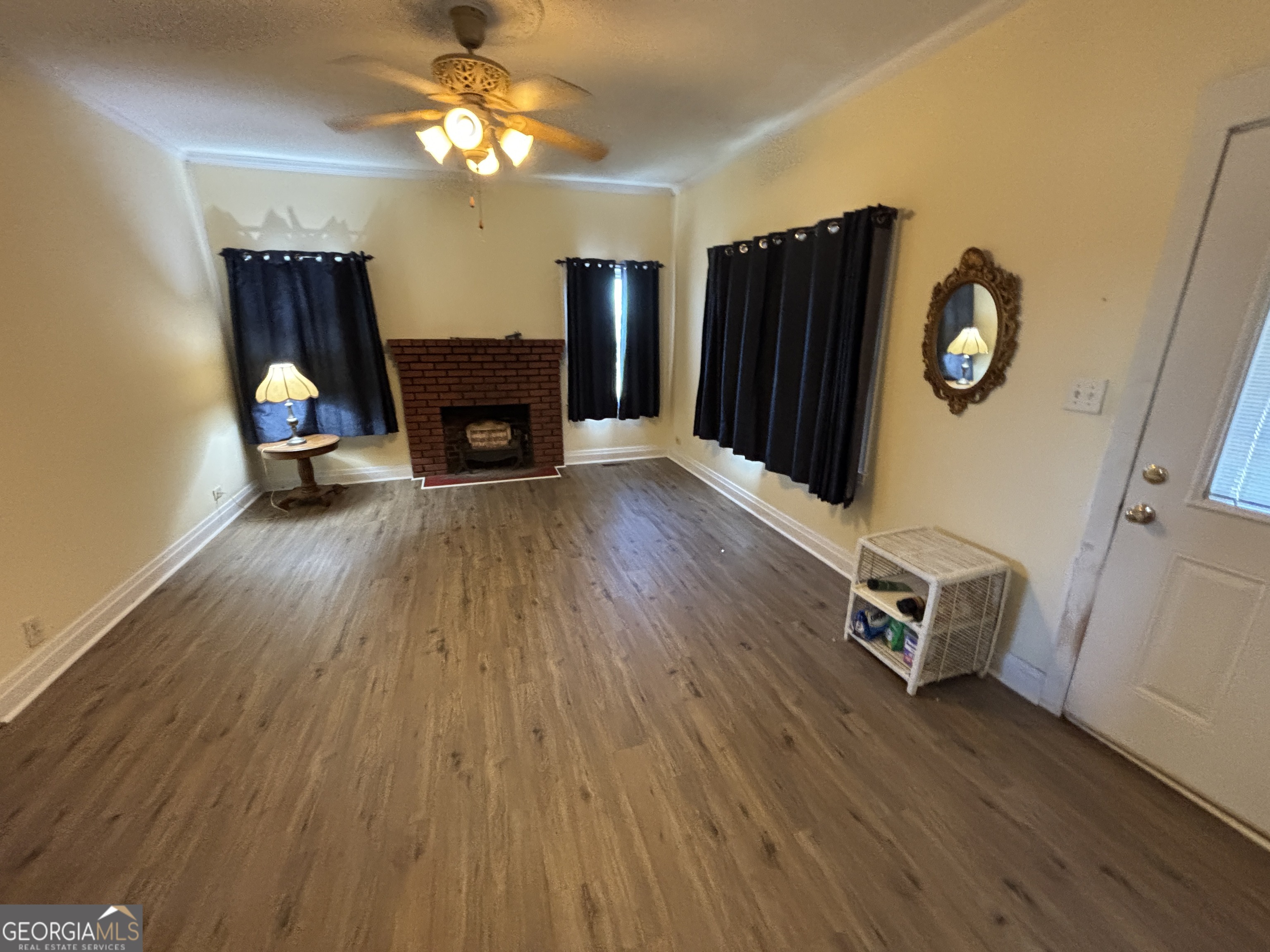 231 Barlow Road Cochran, GA 31014 - Photo 11 of 65 a view of a livingroom with furniture and a wooden floor