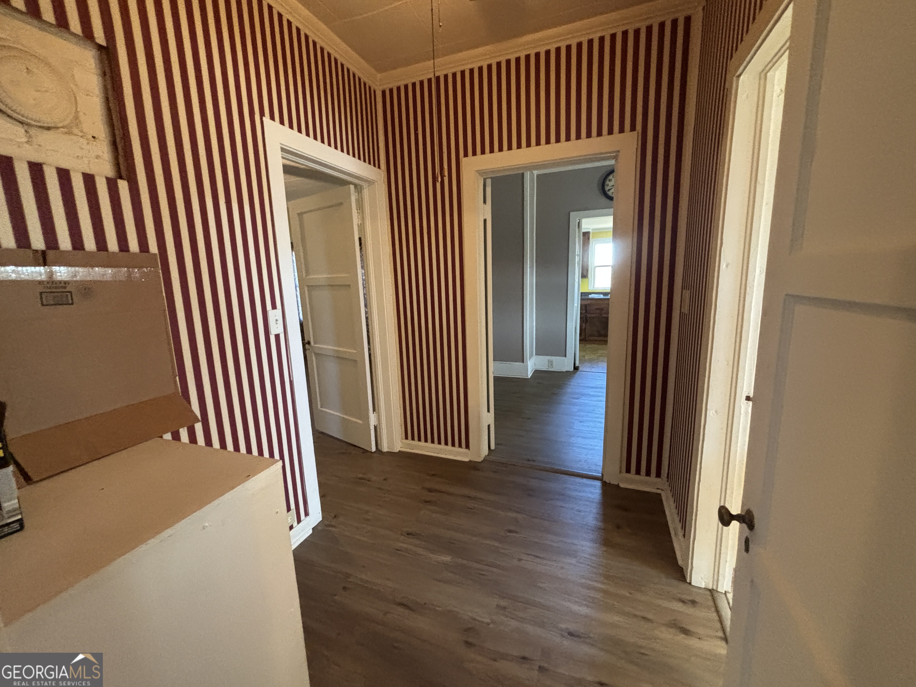 231 Barlow Road Cochran, GA 31014 - Photo 14 of 65 a view of a hallway with wooden floor and a bathroom