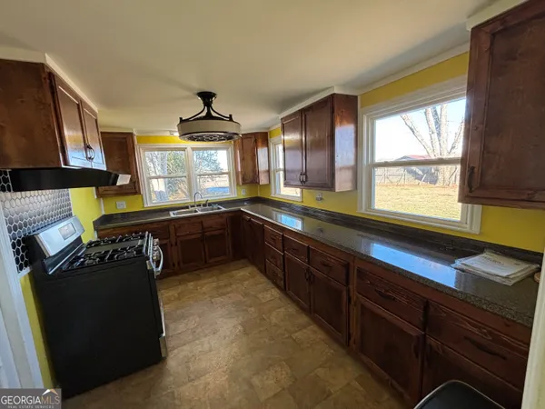 a kitchen with a stove and a sink