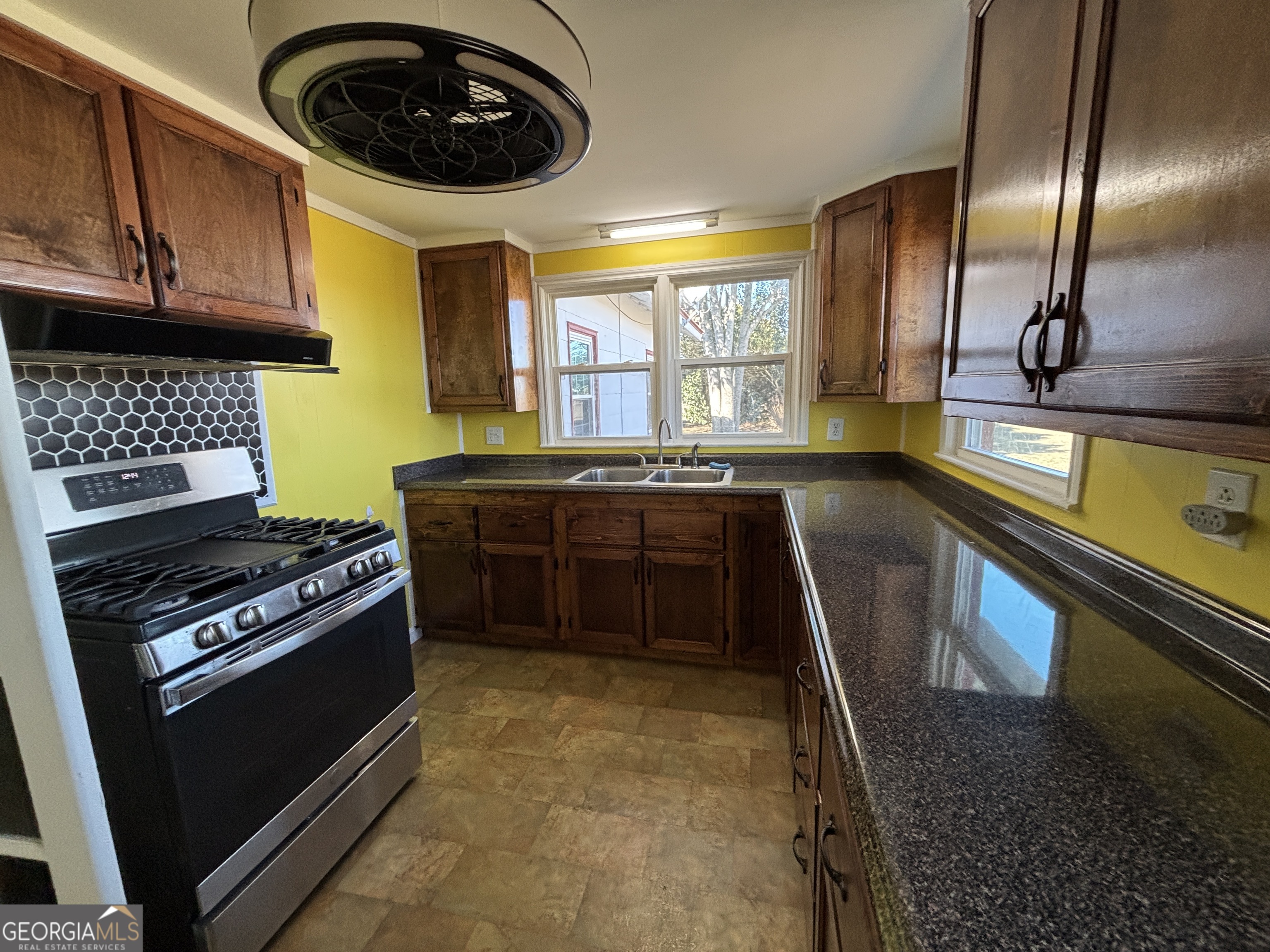 231 Barlow Road Cochran, GA 31014 - Photo 24 of 65 a kitchen with a stove and a sink