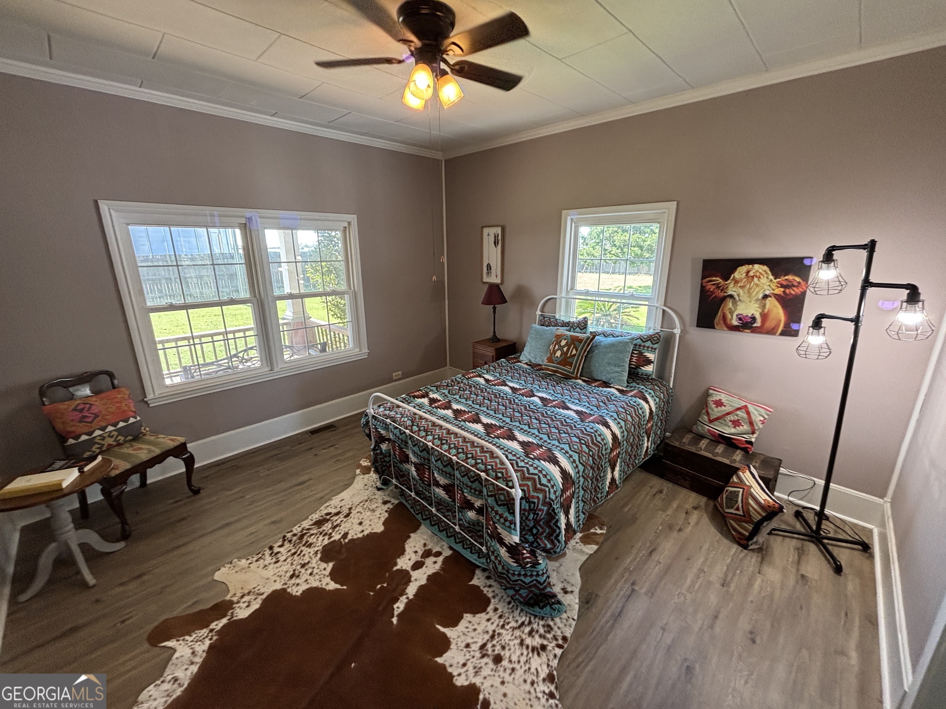 231 Barlow Road Cochran, GA 31014 - Photo 29 of 65 a bedroom with a bed and wooden floor
