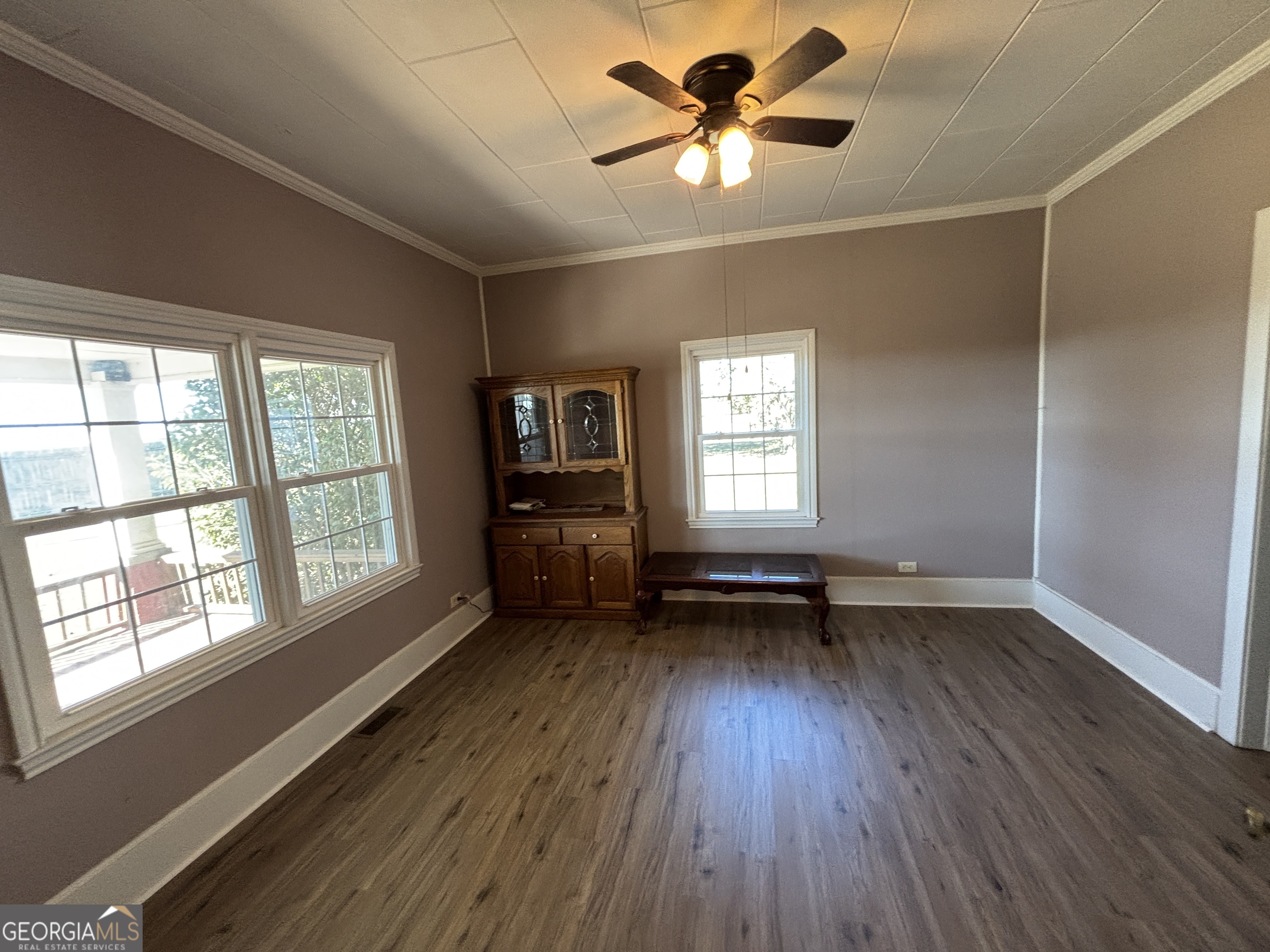 231 Barlow Road Cochran, GA 31014 - Photo 31 of 65 a view of an empty room with a window and wooden floor