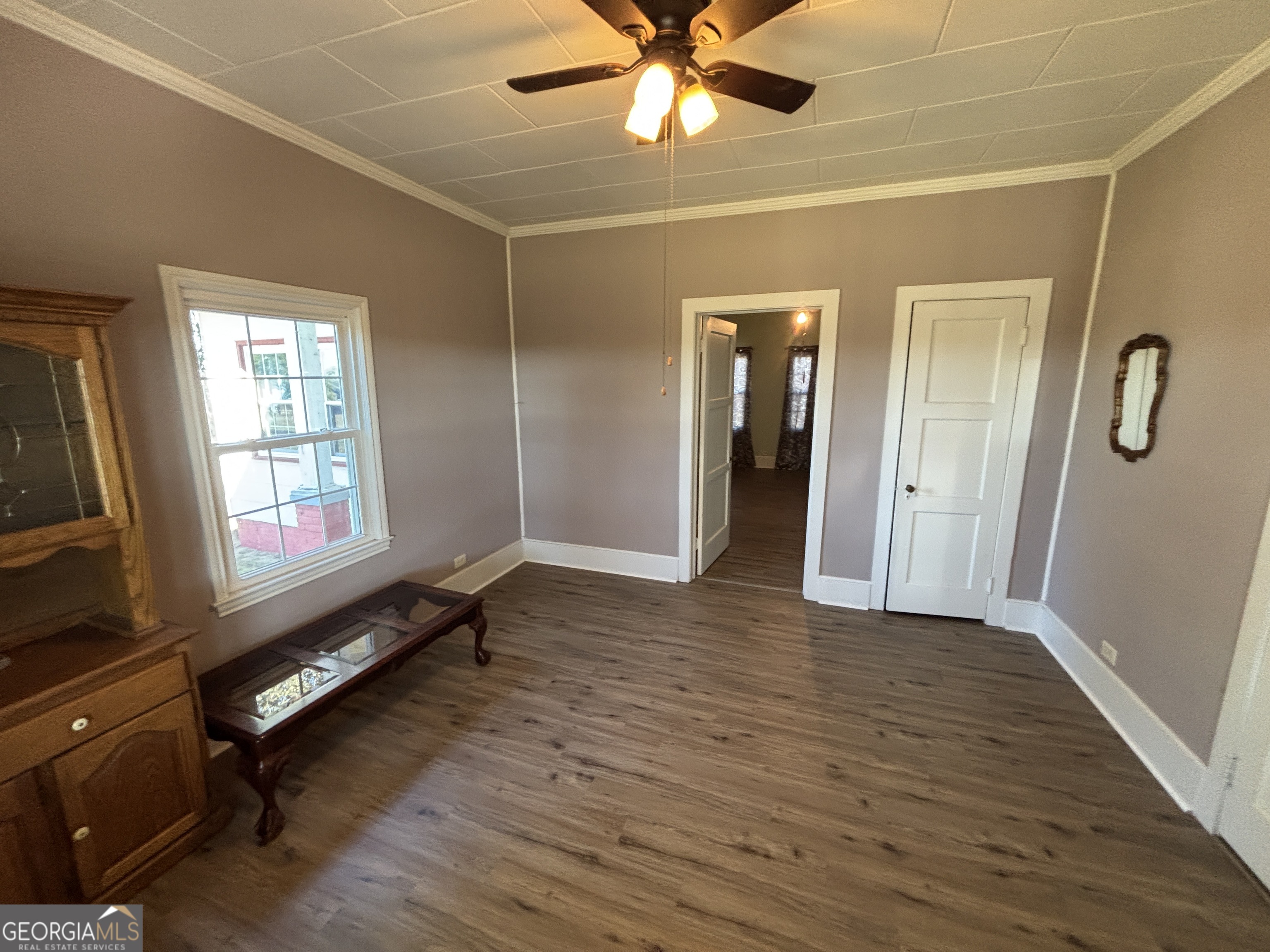 231 Barlow Road Cochran, GA 31014 - Photo 32 of 65 a view of an empty room with window and wooden floor