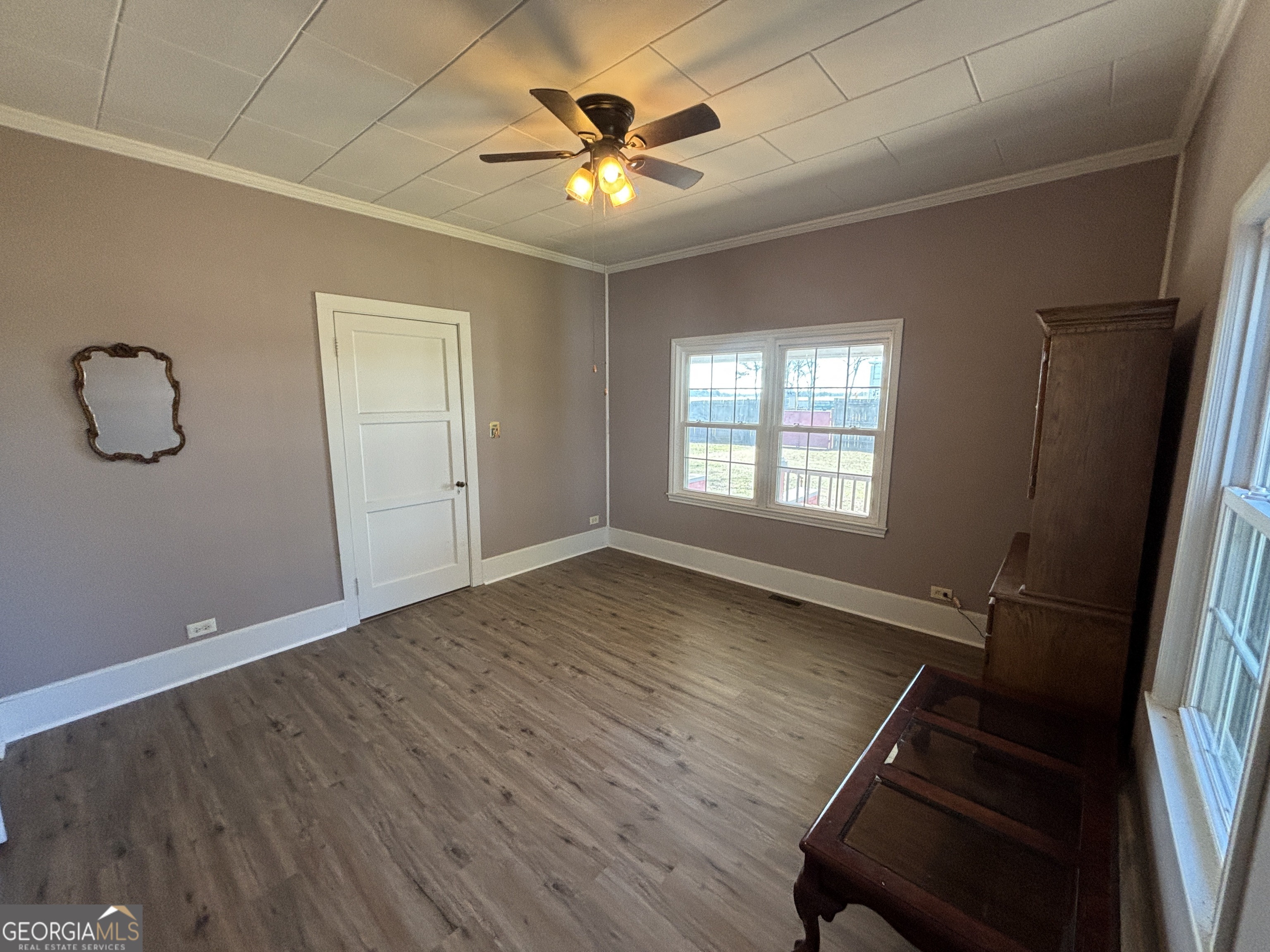 231 Barlow Road Cochran, GA 31014 - Photo 33 of 65 a view of an empty room with window and wooden floor