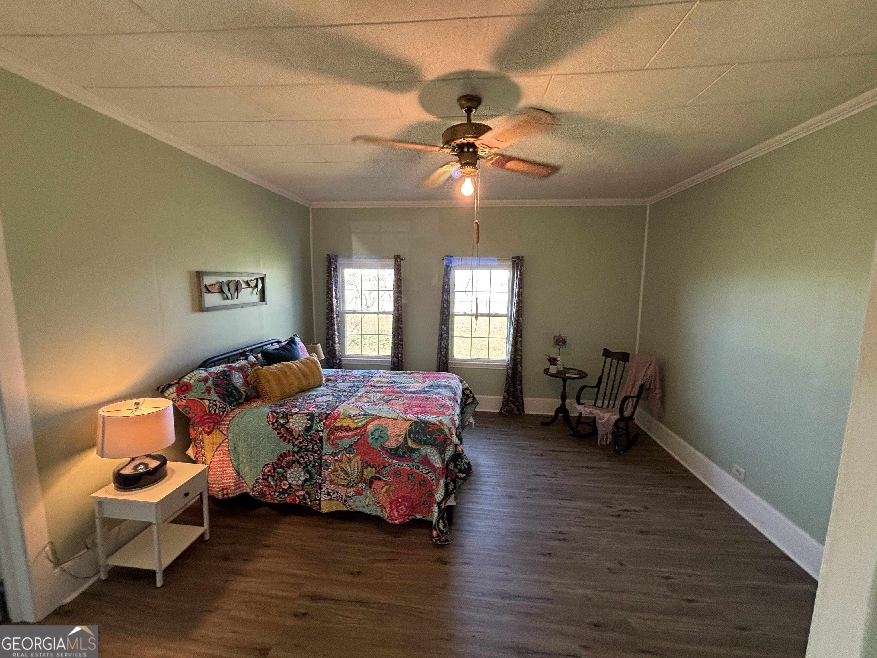 231 Barlow Road Cochran, GA 31014 - Photo 42 of 65 a bedroom with a bed and wooden floor