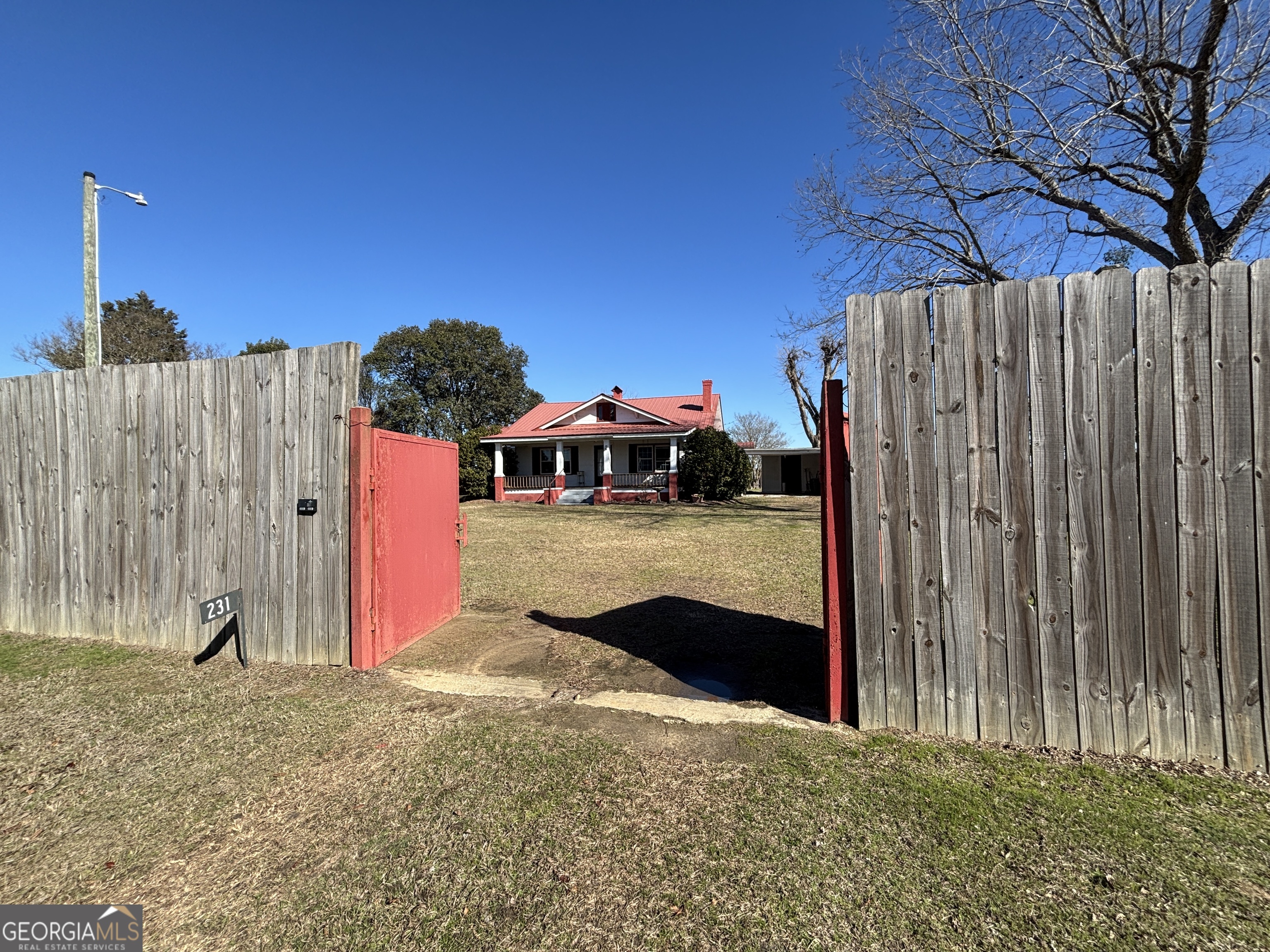 231 Barlow Road Cochran, GA 31014 - Photo 63 of 65 a view of a wooden house with a outdoor space