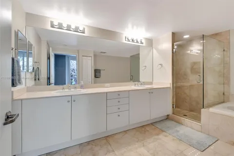 a spacious bathroom with a double vanity sink shower and a mirror