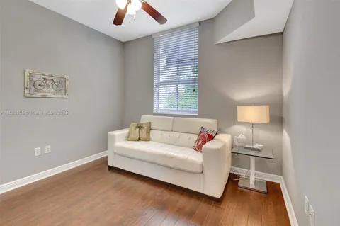 a living room with a bed furniture and a window