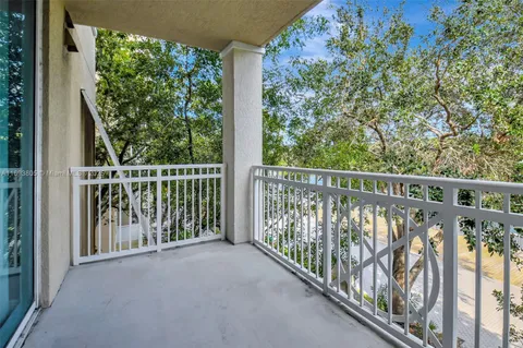 a view of a tall building with a yard and plants