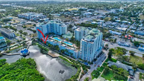 a view of a lake with a big yard and a large trees