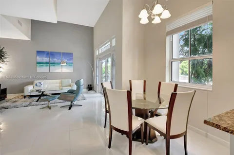 a living room with furniture a chandelier and a window