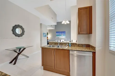 a kitchen with a sink a stove and cabinets