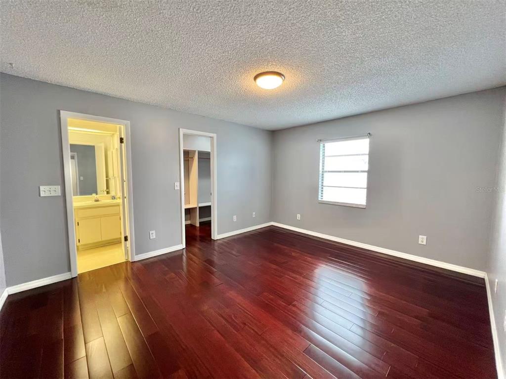 8341 Duval Drive Port Richey, FL 34668 - Photo 12 of 27 a view of an empty room with wooden floor and a window