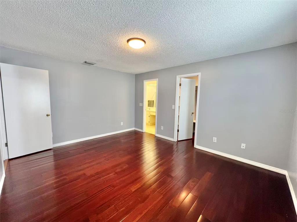 8341 Duval Drive Port Richey, FL 34668 - Photo 13 of 27 a view of an empty room with wooden floor and a window