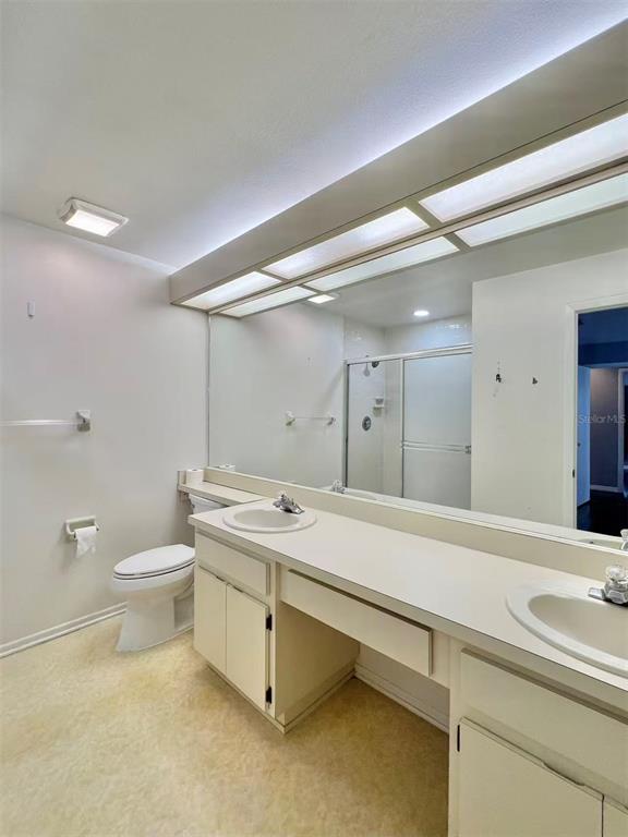 8341 Duval Drive Port Richey, FL 34668 - Photo 15 of 27 a bathroom with a double vanity sink toilet and a tub