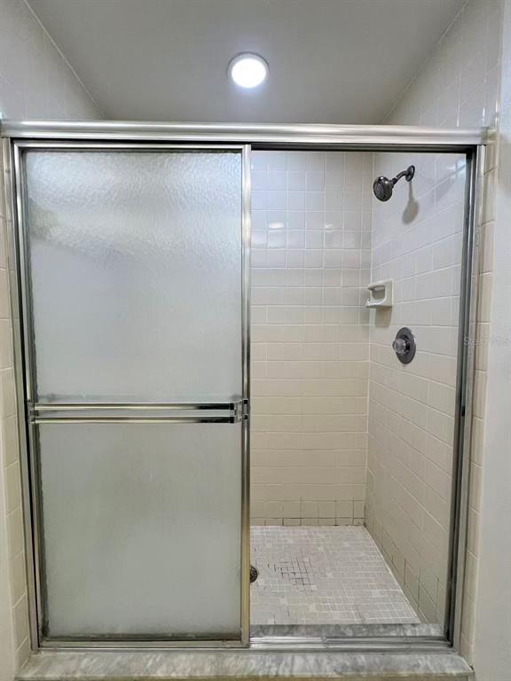8341 Duval Drive Port Richey, FL 34668 - Photo 16 of 27 a bathroom with a glass shower