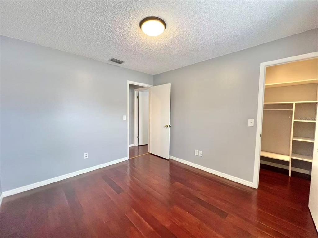 8341 Duval Drive Port Richey, FL 34668 - Photo 19 of 27 an empty room with wooden floor and window