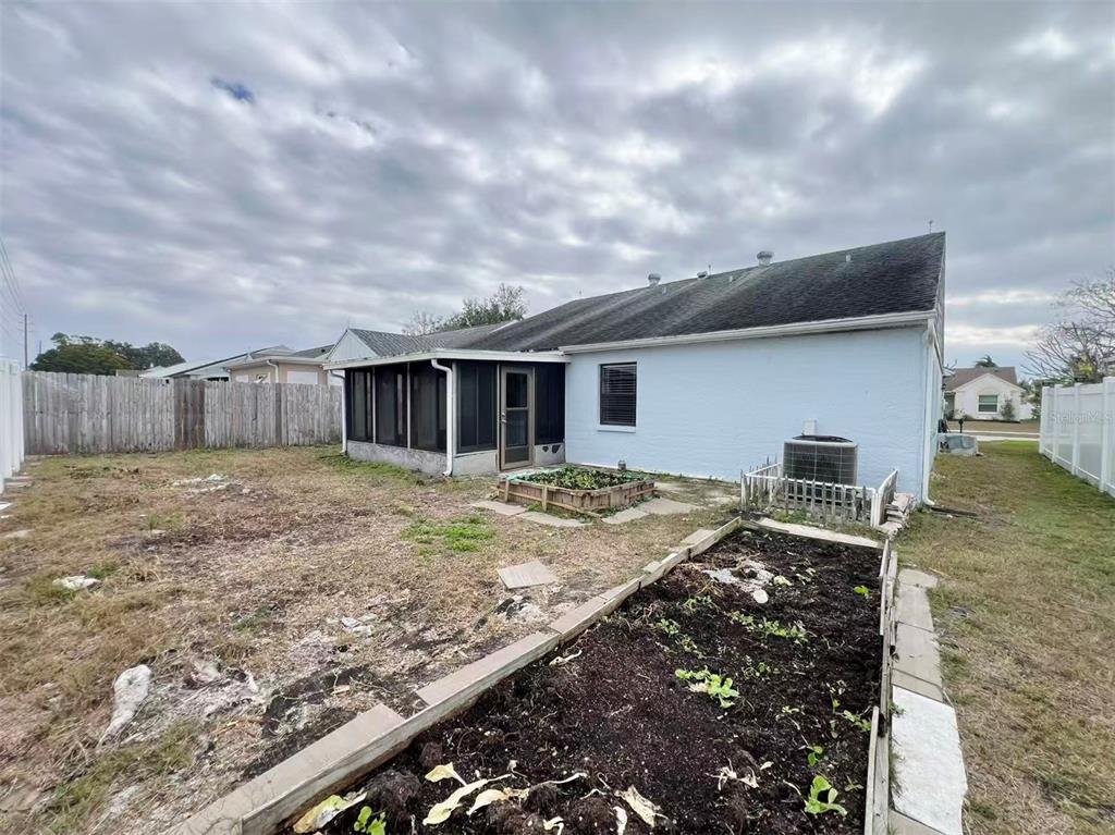 8341 Duval Drive Port Richey, FL 34668 - Photo 24 of 27 a view of house with backyard and deck