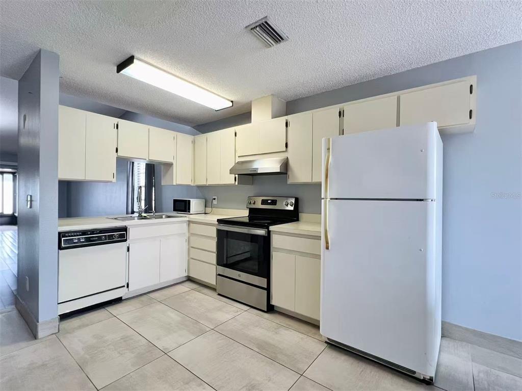 8341 Duval Drive Port Richey, FL 34668 - Photo 5 of 27 a kitchen with cabinets and stainless steel appliances