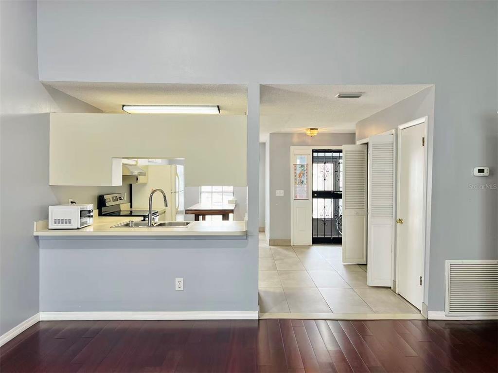 8341 Duval Drive Port Richey, FL 34668 - Photo 10 of 27 a view of a kitchen with kitchen island a sink wooden floor and refrigerator