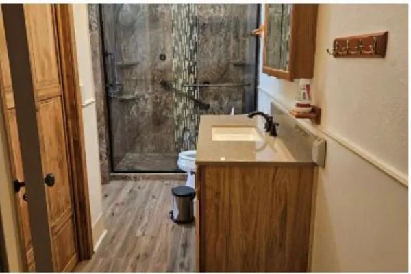a bathroom with a sink toilet and shower
