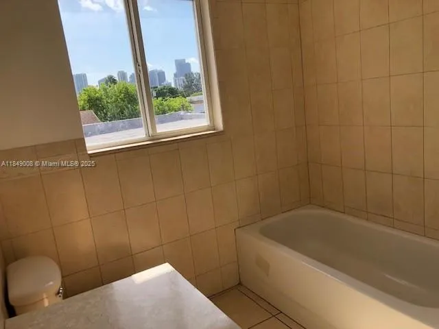 a bathroom with a bathtub and window
