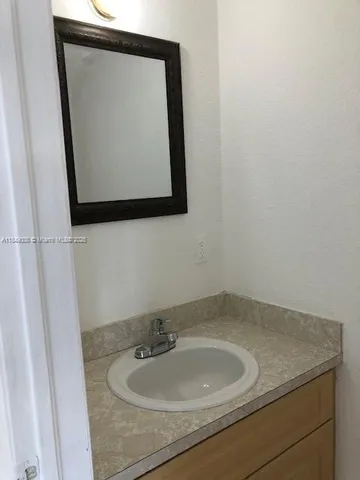 a bathroom with a sink and mirror