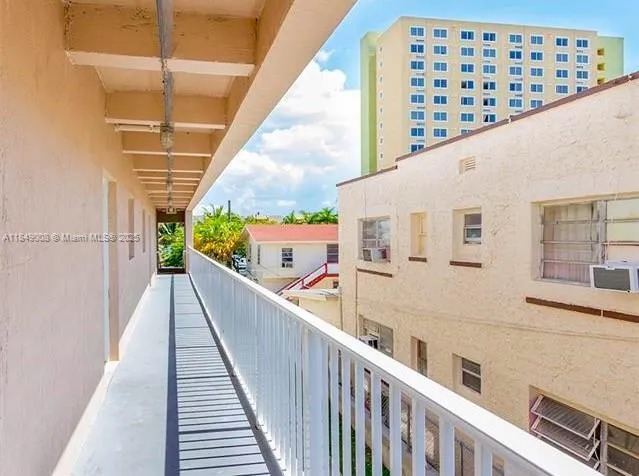 a view of balcony with wooden floor and fence
